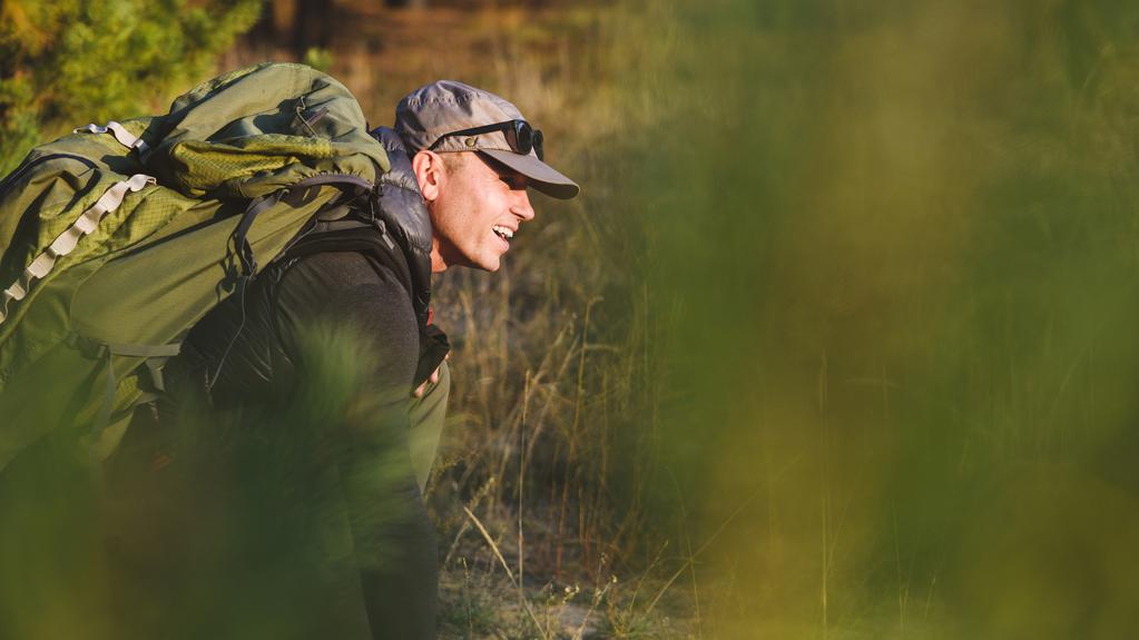 Older man walking relaxed on a paved trail